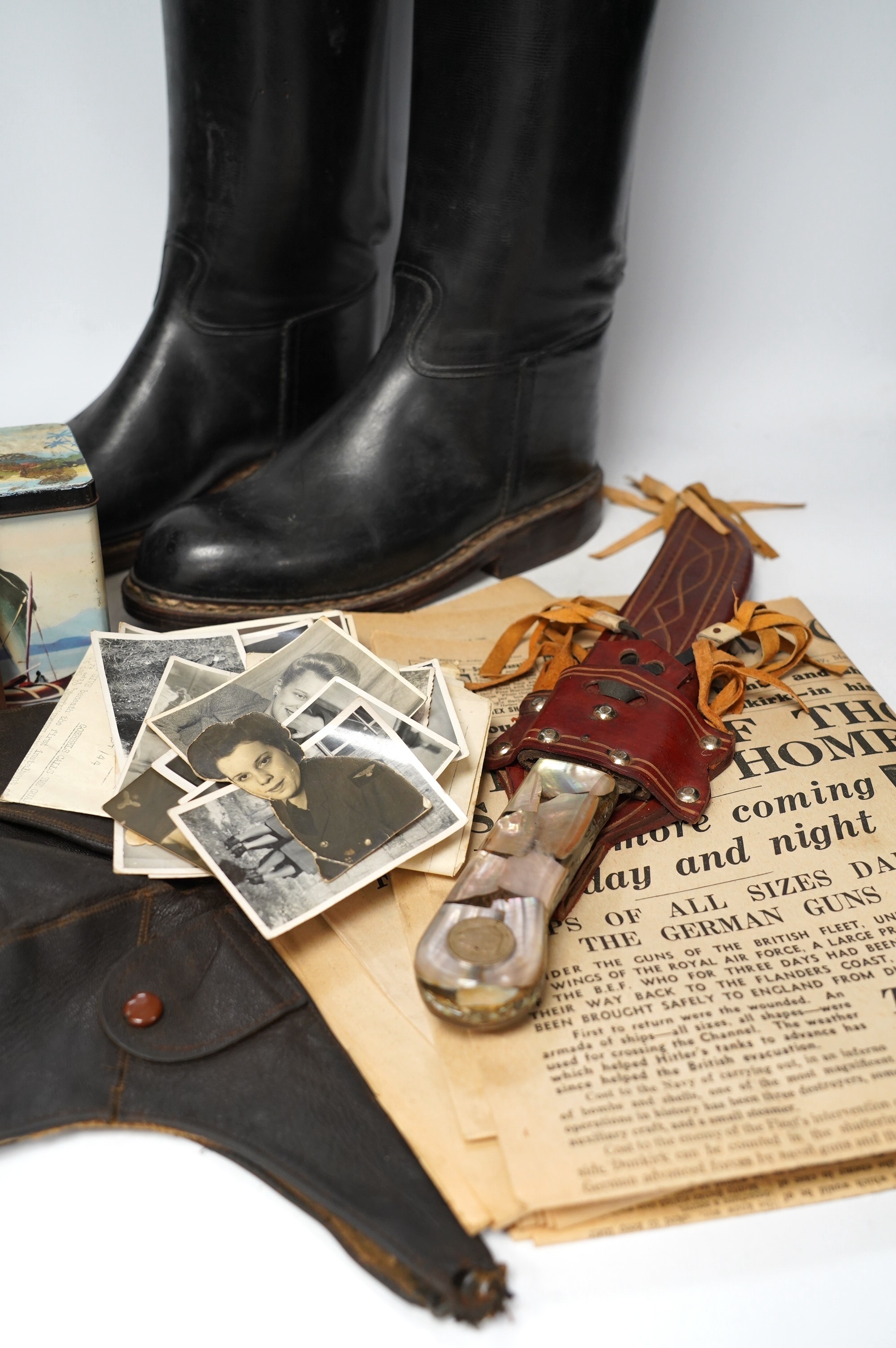 A collection of militaria and WWII related items including; three 1940s copies of the Daily Express with articles related to key events including Dunkirk, a knife in a leather scabbard, a number of photos, an aviation ca